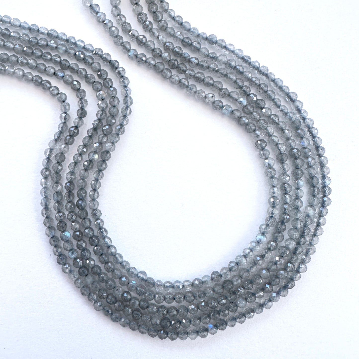 Close-up of Labradorite faceted rondelle beads with natural shimmer and polished finish.