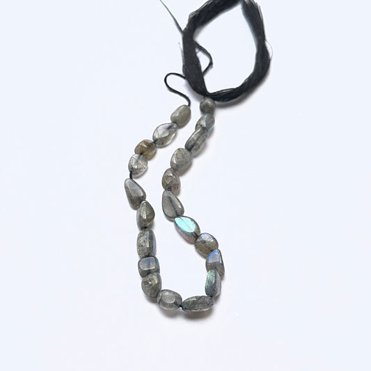 Close‑up of Labradorite stone beads in smooth tumbled, highlighting shimmer for handmade jewellery components.