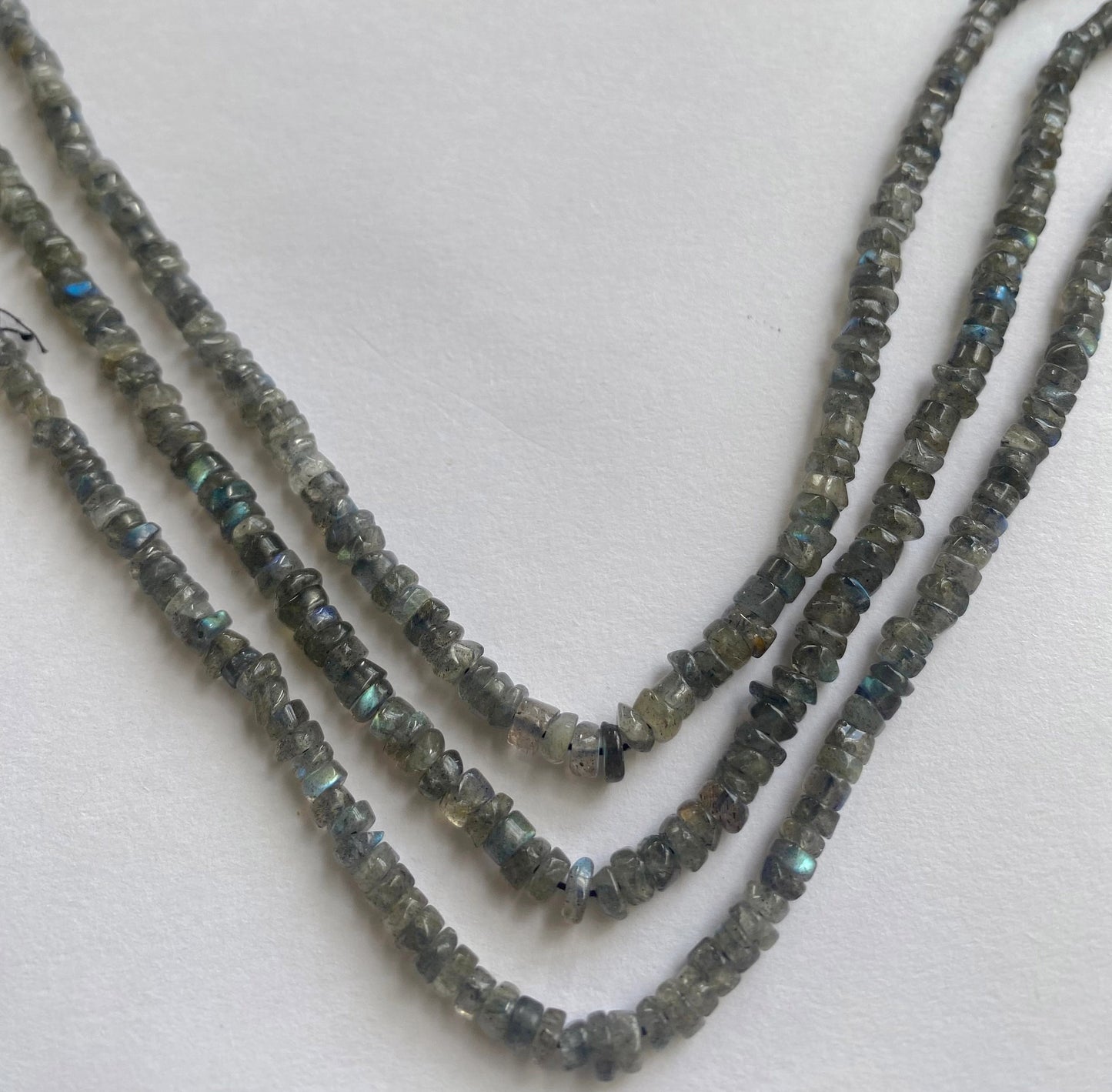 A beautifully strung 33cm strand of Labradorite smooth wheel beads with luminous color shifts.