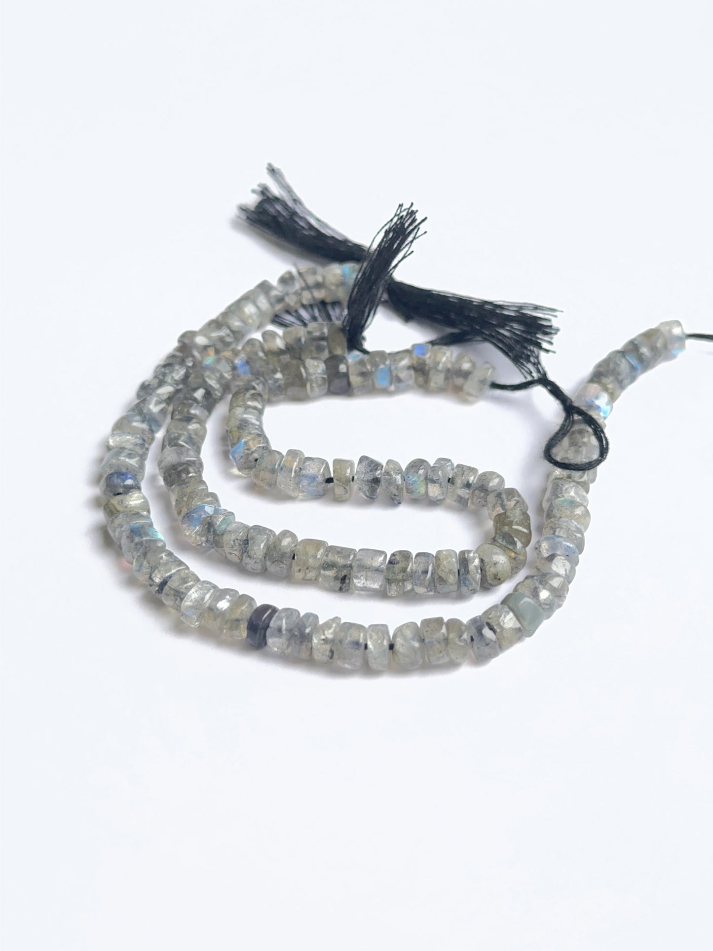 Delicate strands of labradorite smooth wheel heishi beads, showcasing their smooth design.