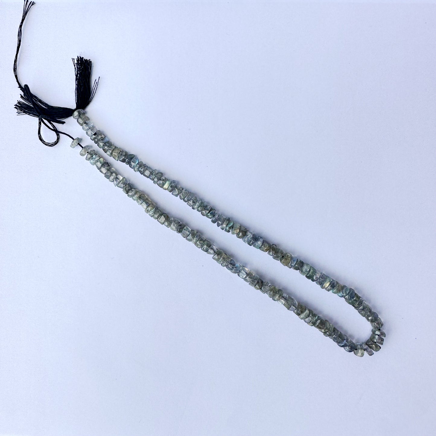 High-grade Labradorite wheels with 0.5mm bead holes and subtle iridescent tones.