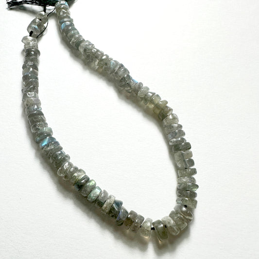 Natural gemstone beads for DIY jewellery featuring 6-6.2mm Labradorite wheels with polished finish and iridescent tones.