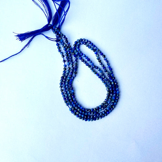 Lapis Lazuli beads arranged in a strand with consistent cut and natural shine.