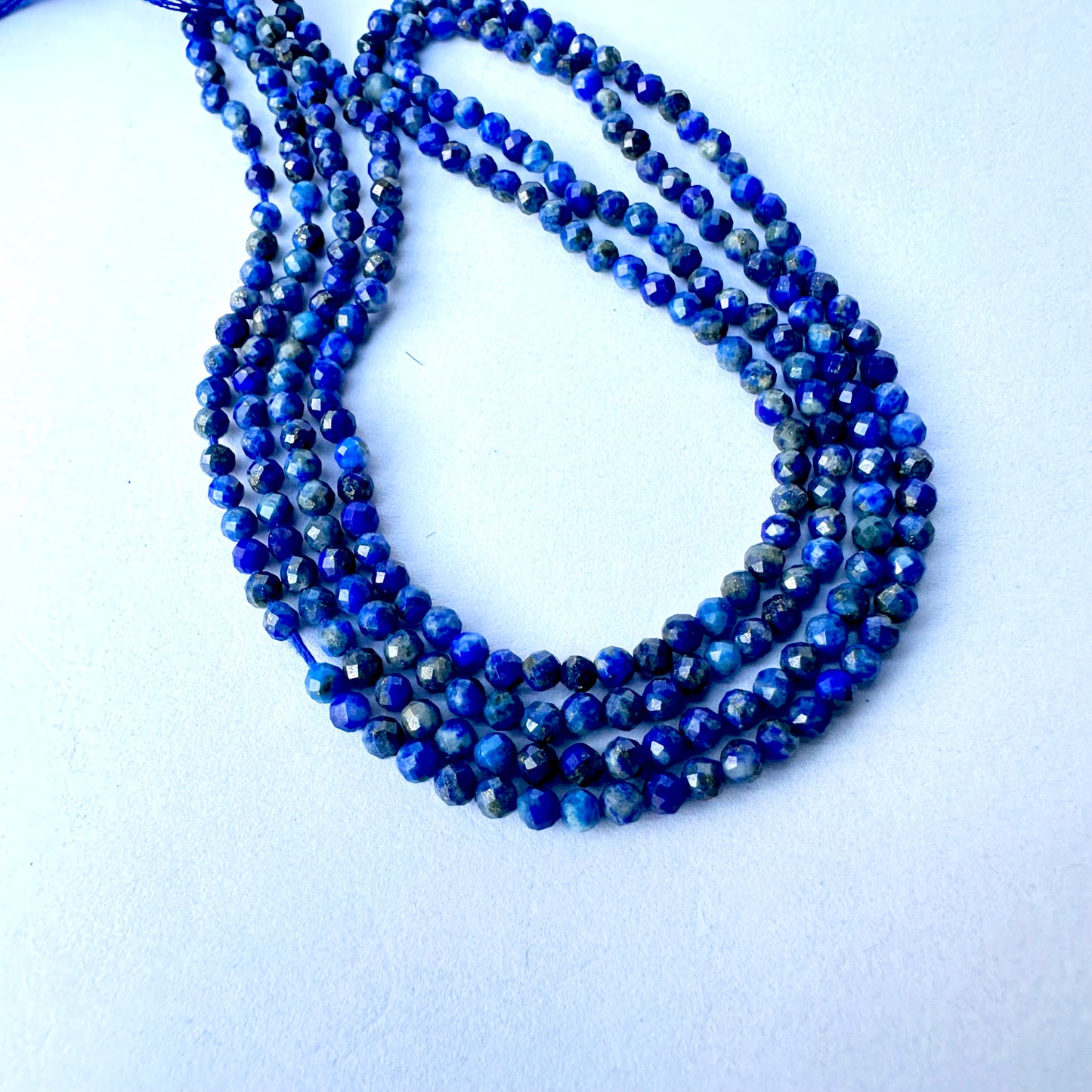 Close-up of Lapis Lazuli beads showing deep blue colour.