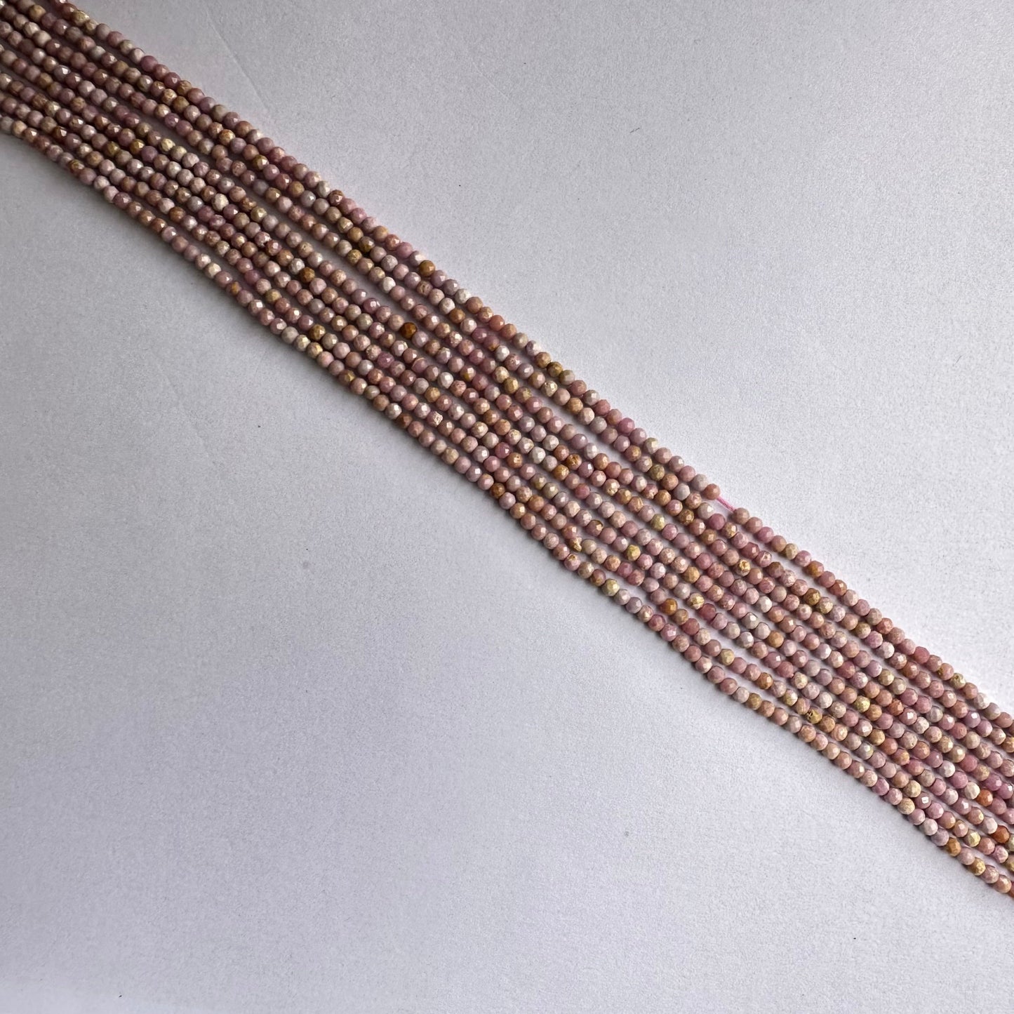 Strand of Lavender Opal beads showcasing consistent size and elegant sparkle.