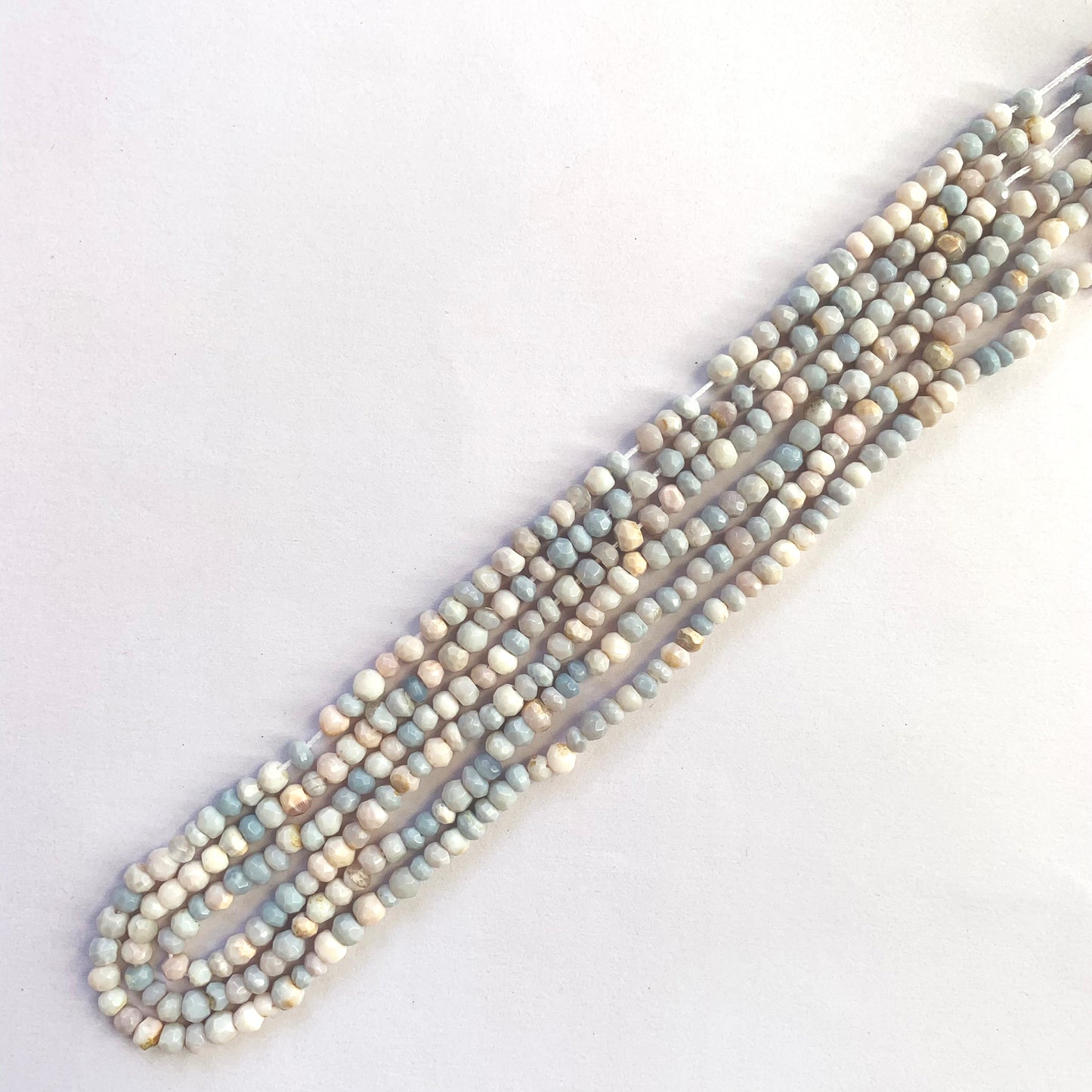 Lavender opal faceted rondelles reflecting light on a clean 32cm thread.