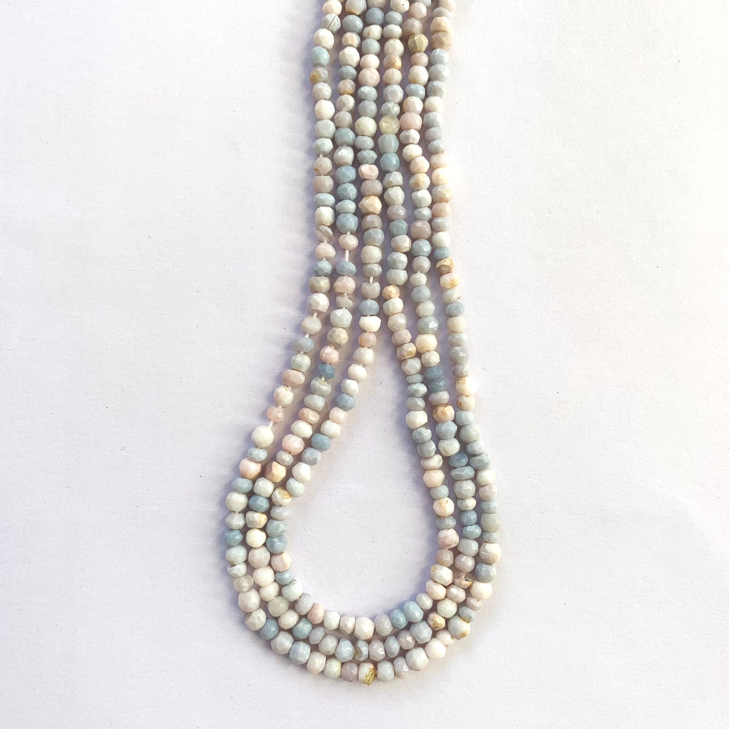 Pastel-hued lavender opals cut in rondelle shape, glimmering across a 32cm length.
