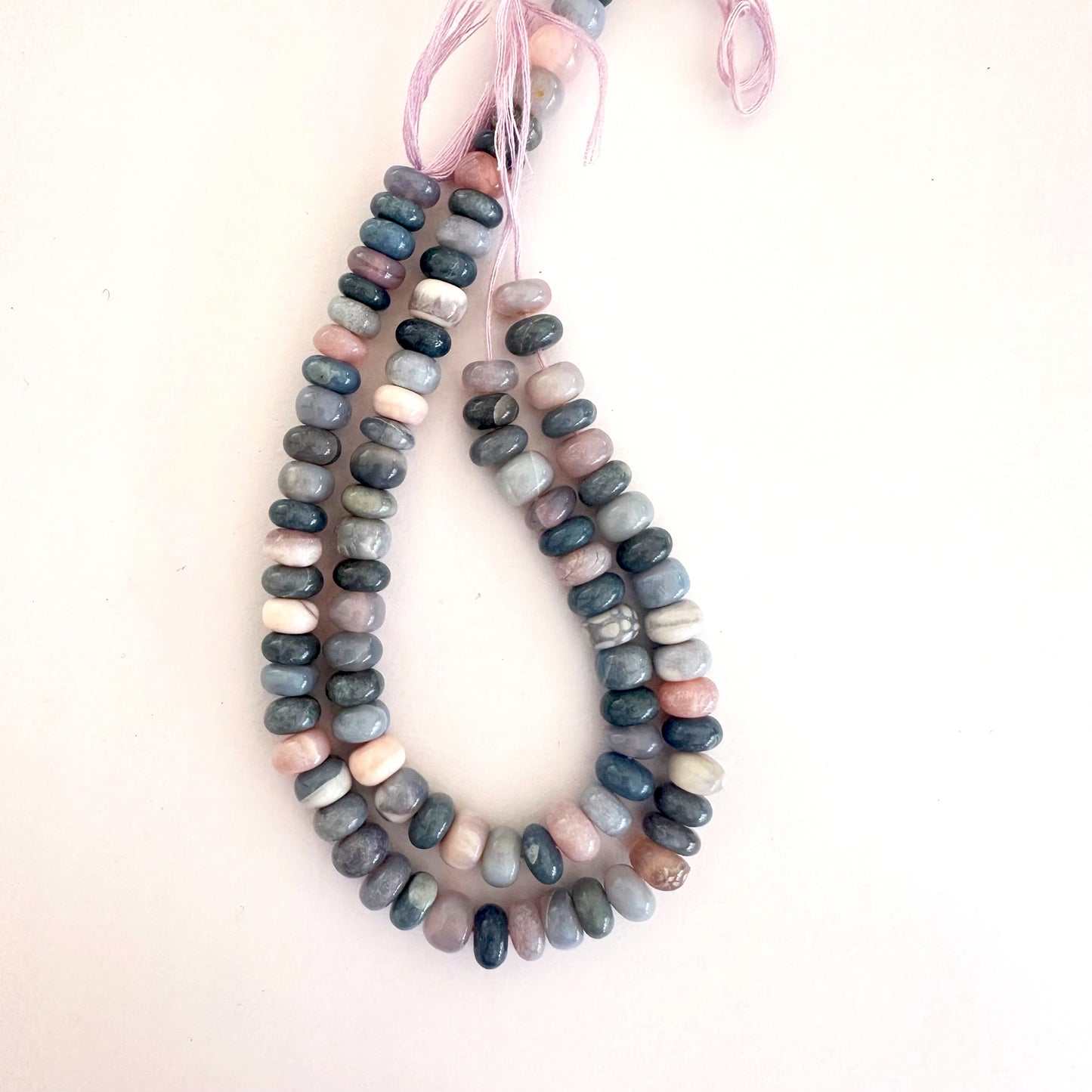A string of polished Lavender Opal rondelle beads with soft lilac hues and glossy finish.