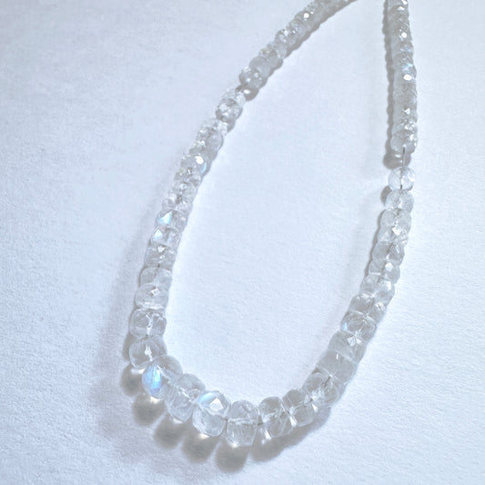 Close-up of natural gemstone beads for DIY jewellery showing faceted cut and luminous colour play.