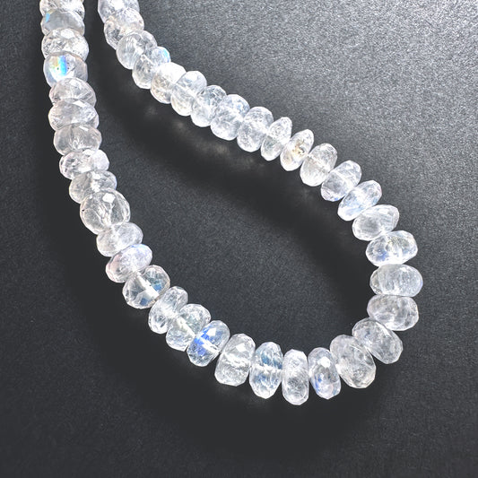 Stone beads with faceted Moonstone arranged neatly, ideal for handmade jewellery components.