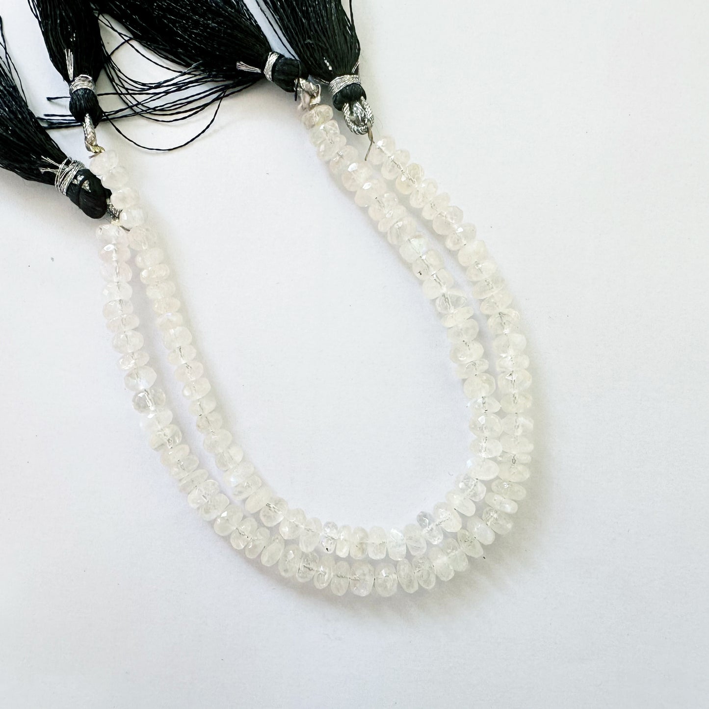 Moonstone rondelle beads in 6.3–6.5mm size with soft glow and faceted precision on a 20cm strand.
