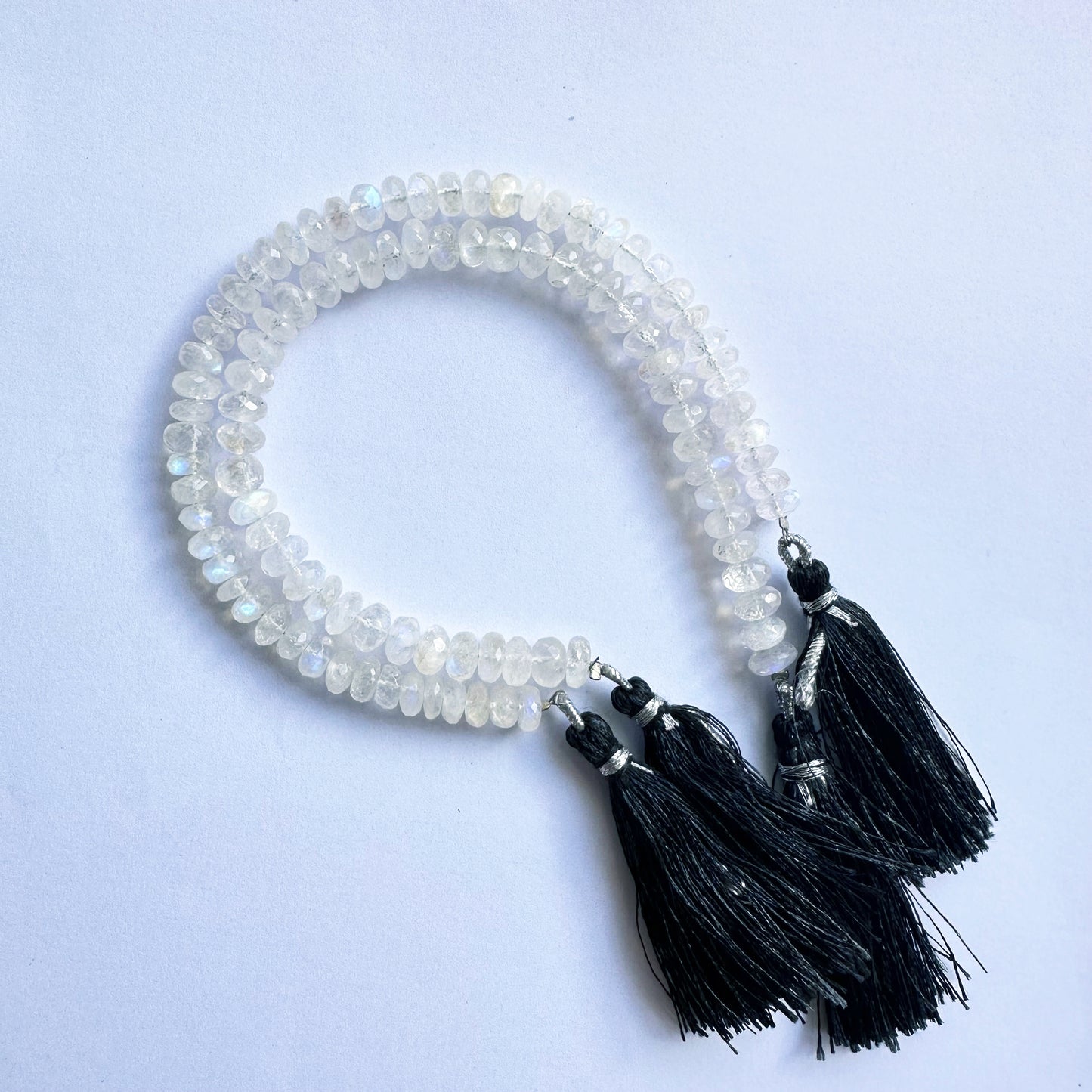 Close-up of Moonstone rondelle beads in 6.5–7.5mm size showing precise cut and clarity.