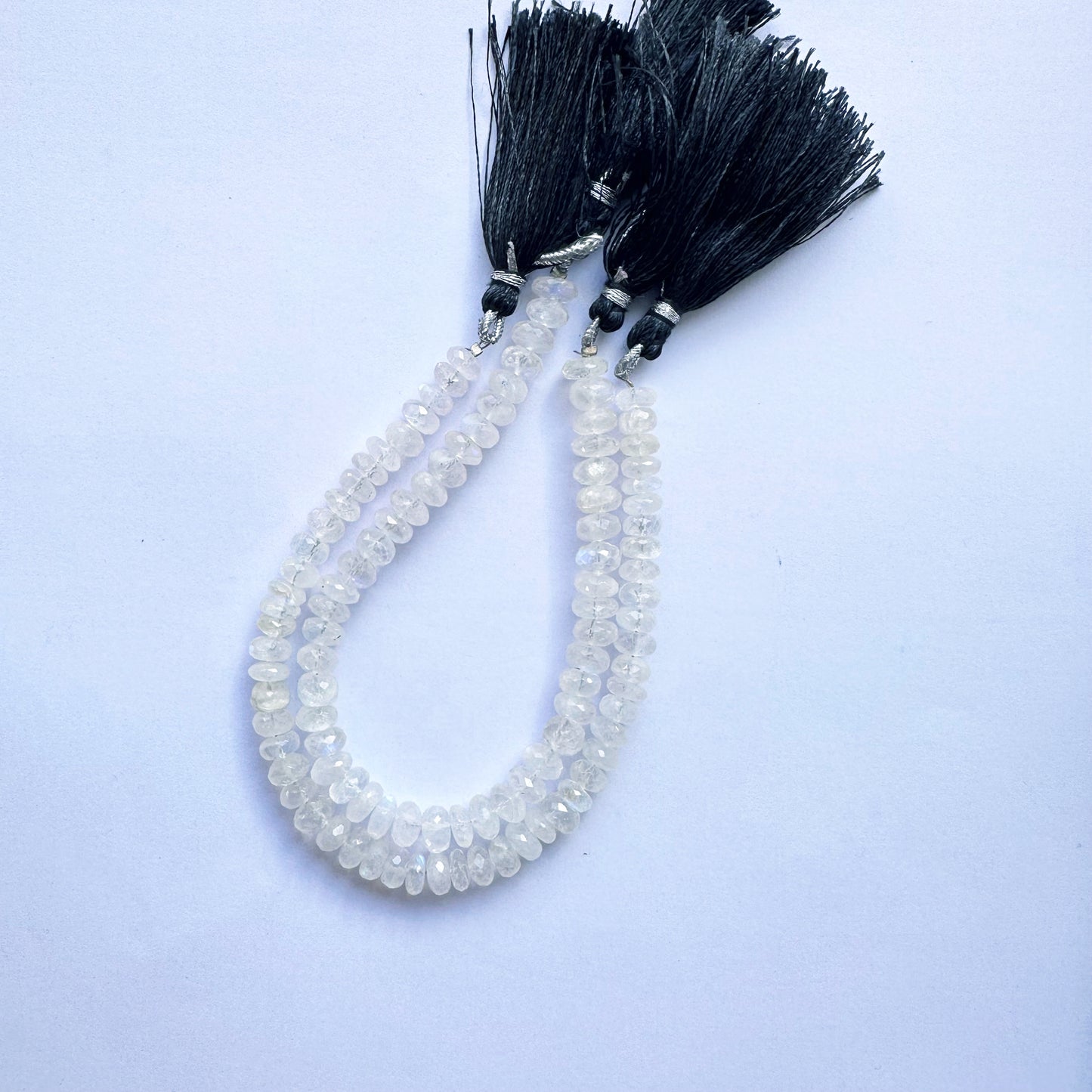 Moonstone beads with faceted rondelle cut arranged on a 20cm strand, glowing with soft hues.