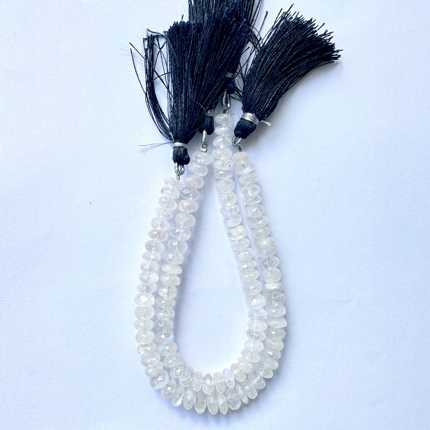 Close-up view of 7.2–7.5mm moonstone rondelle beads showing glossy finish and clarity.