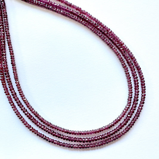 Close-up of natural gemstone beads for DIY jewellery showing glossy surface and consistent round shape.