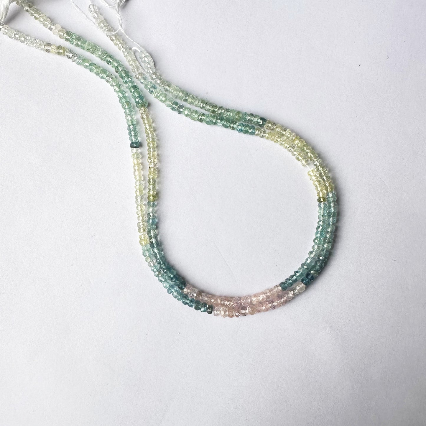 Glittering arrangement of Multi Aquamarine beads aligned in rondelle formation.