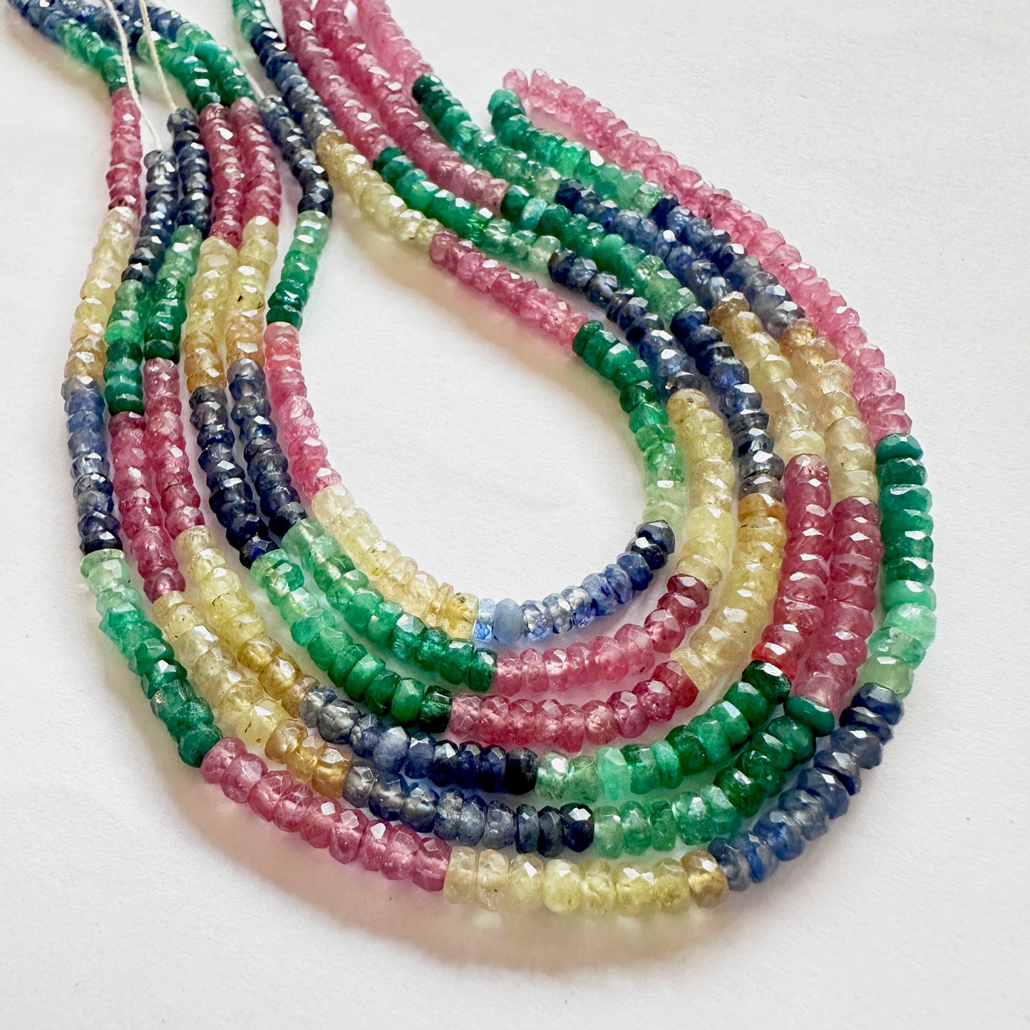 Multi-gemstone strand featuring rubies, sapphires and emeralds with excellent lustre.