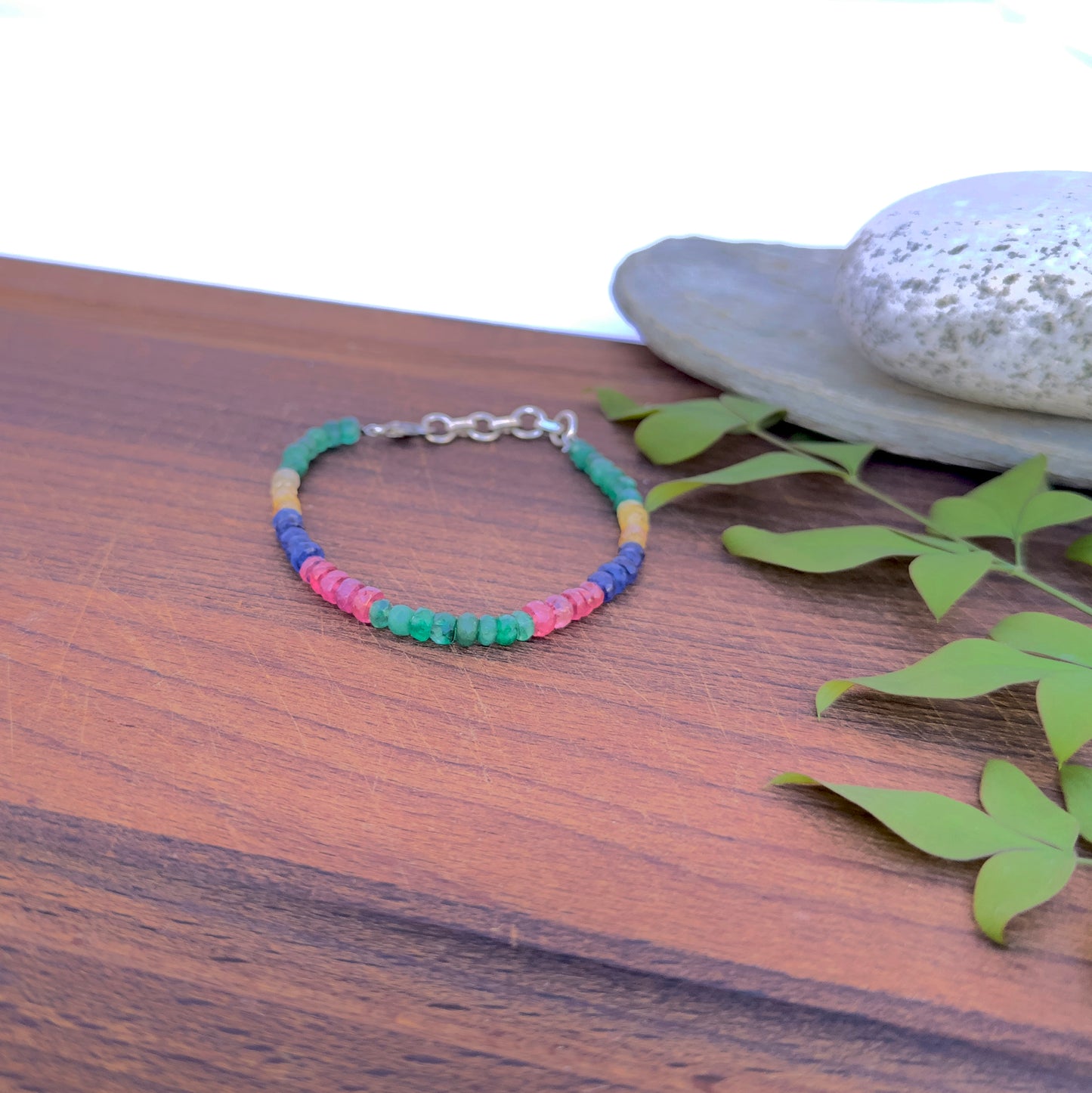 Natural gemstone bracelet with 4.5–5mm faceted beads in rich jewel tones.