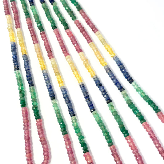 Close view of ruby, blue sapphire, yellow sapphire and emerald faceted rondelles on a 39cm strand for handmade jewellery components.