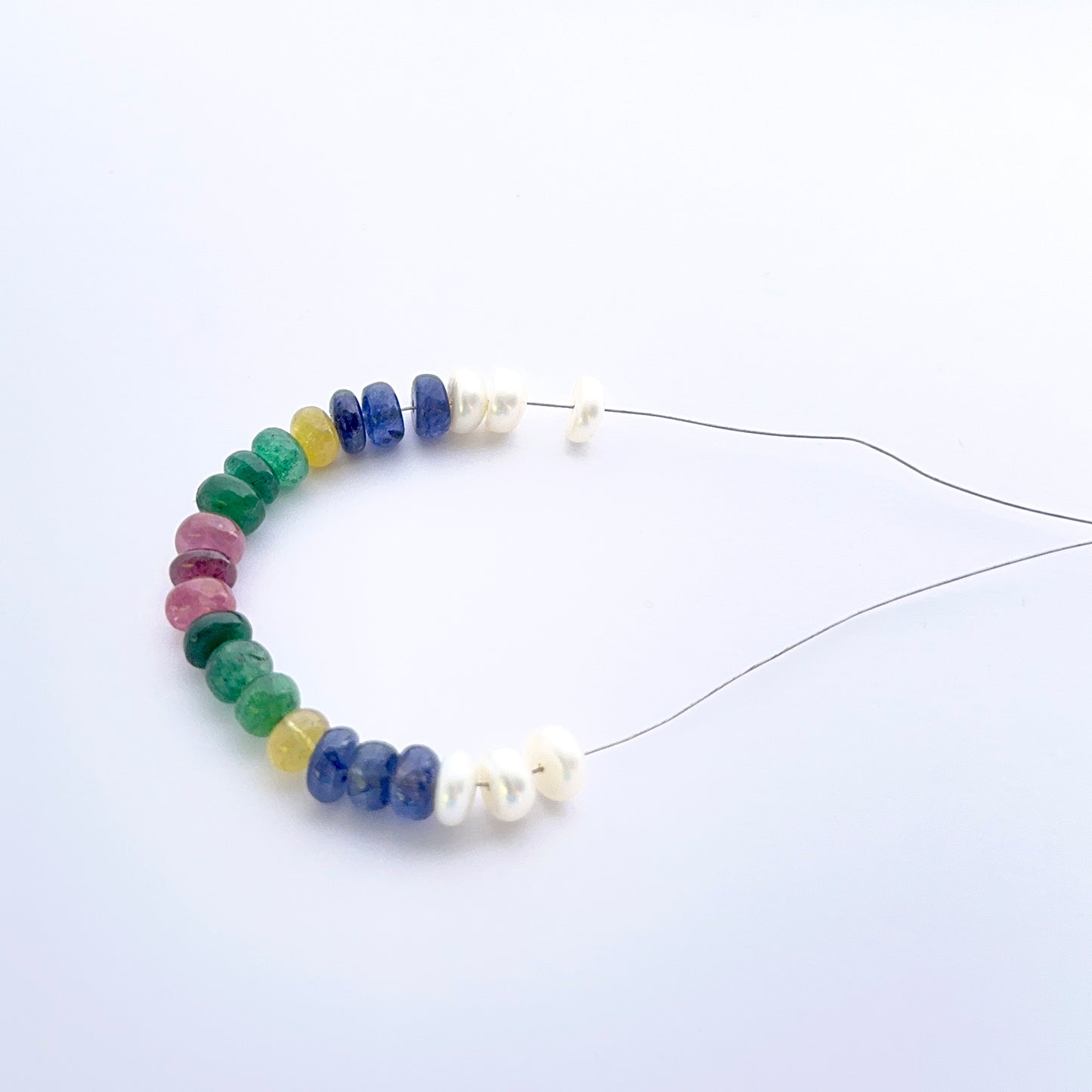 Multi precious gemstone and freshwater pearl smooth rondelle beads 6.2–6.7mm displaying consistent shape and elegant tones.