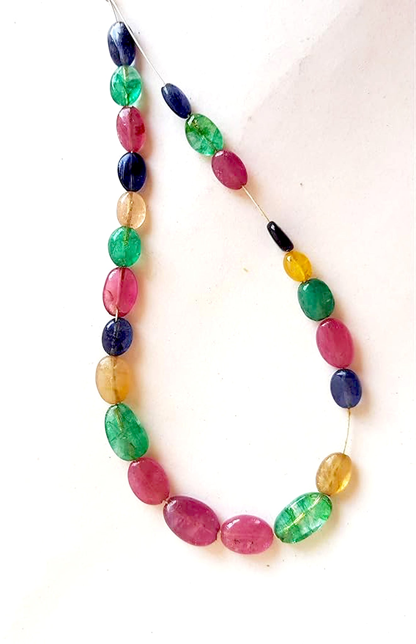 Emerald and multi precious gemstone beads arranged neatly to highlight uniformity and 45 carats of fine craftsmanship.