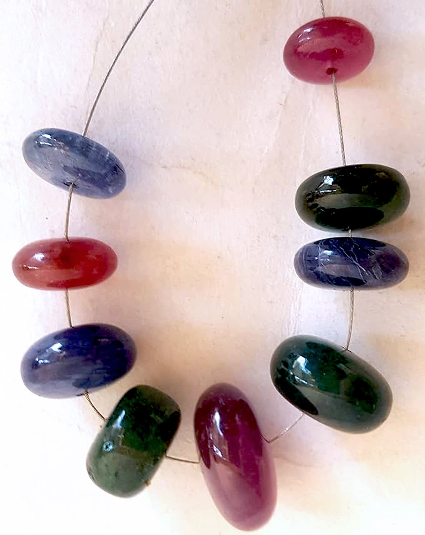 Blue sapphire, ruby, and emerald rondelle beads shine with smooth polish and rich colour across 82 carats.