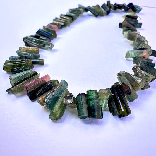Close-up of Multi Tourmaline stone beads showing rough cut and natural gemstone texture.