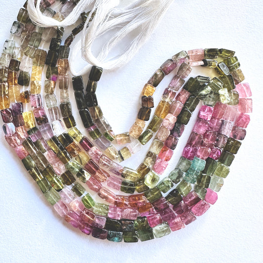 Close-up of 4.4-4.6mm Multi Tourmaline stone beads showing polished surface and colour variation.