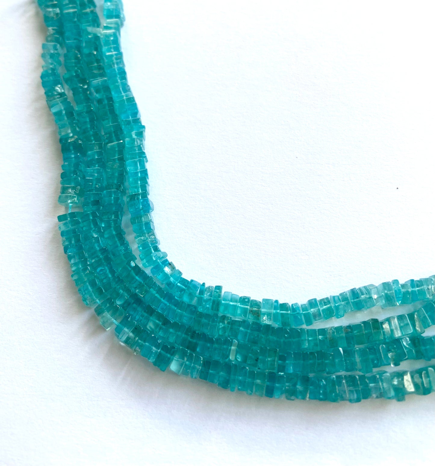 Neon Apatite square heishi beads in vivid teal-blue tones, strung on a 20cm strand.