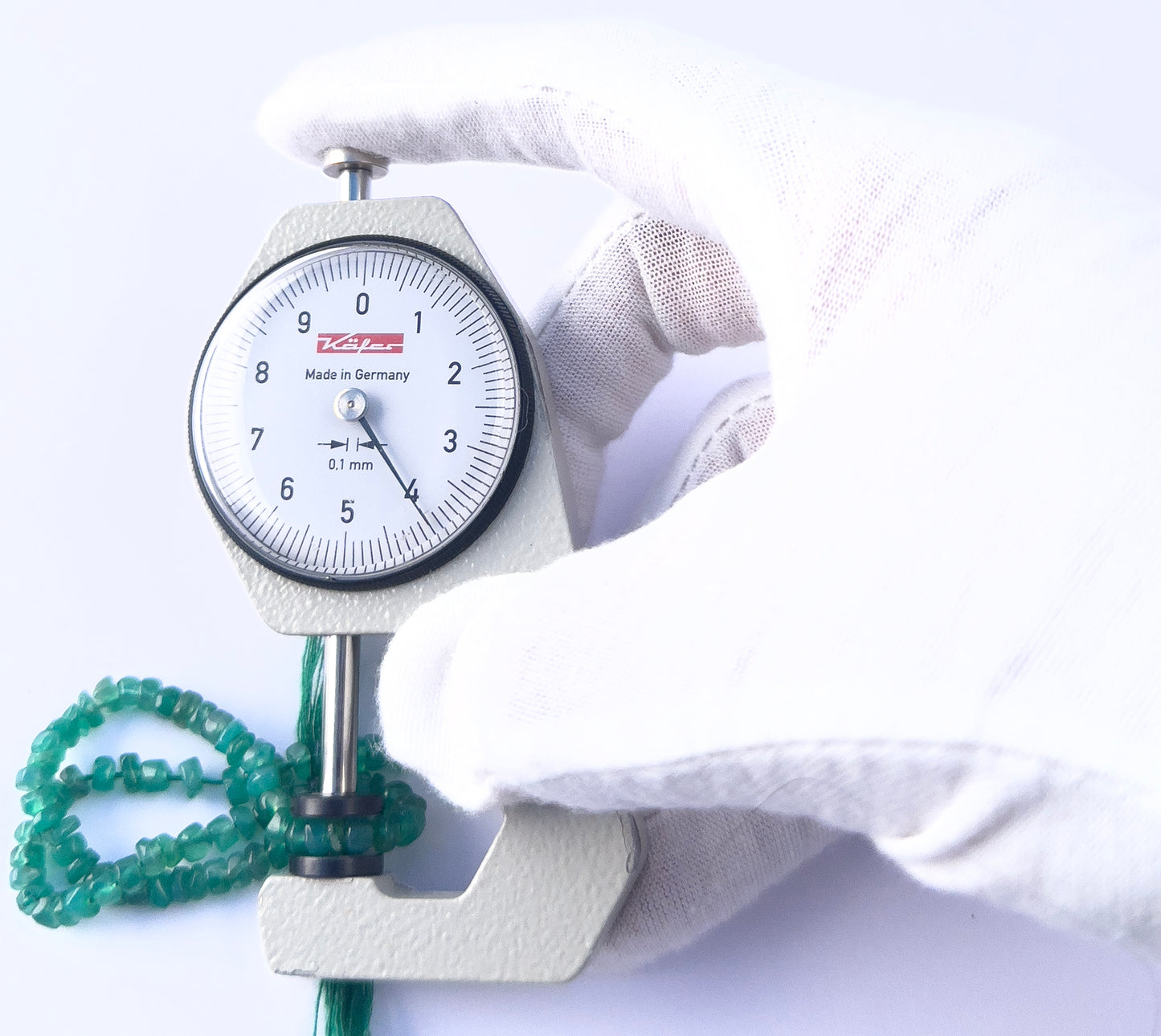 A dial gauge measures the Onyx smooth wheel 4-4.2mm gemstone.