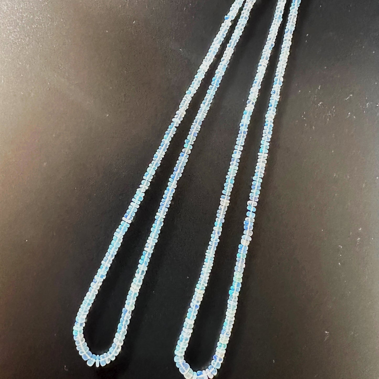 High-quality Opal rondelles with 0.4mm to 0.5mm bead holes and polished finish.