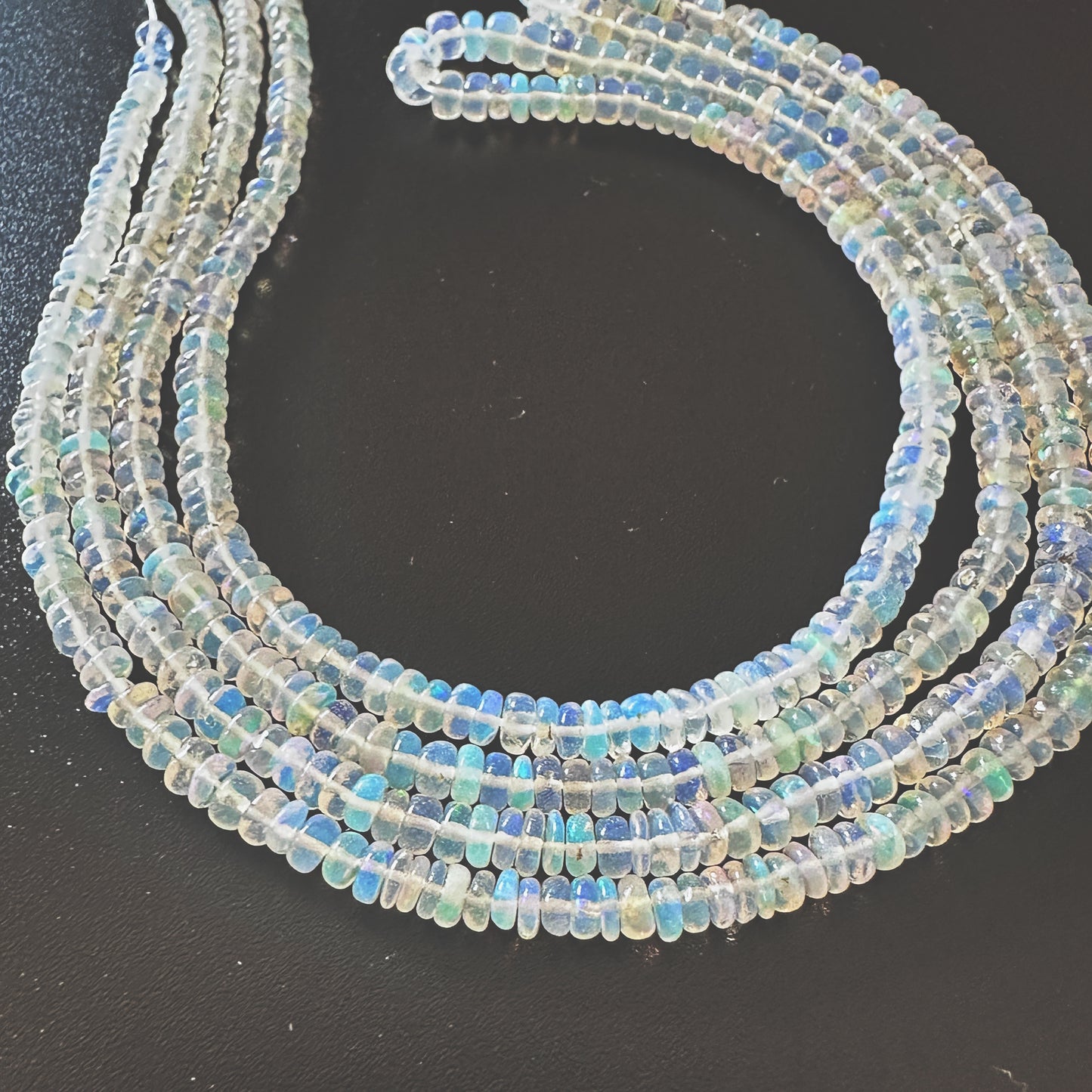 Natural Opal gemstone beads with smooth rondelle cut and luminous pastel tones.