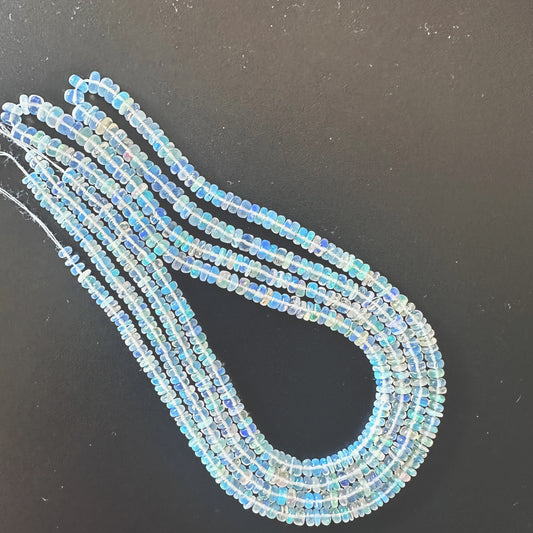 Opal beads arranged in a flowing strand with gentle shine and consistent shape.