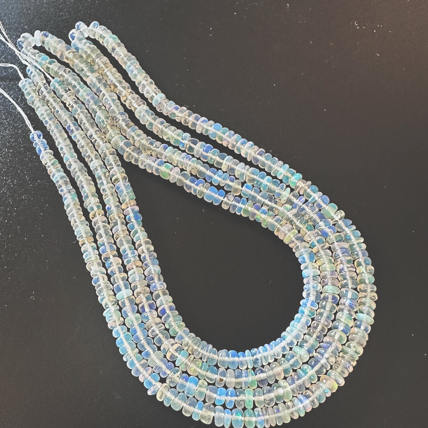 Close-up of 3.2-4.0mm Opal beads showing smooth surface and natural colour variation.