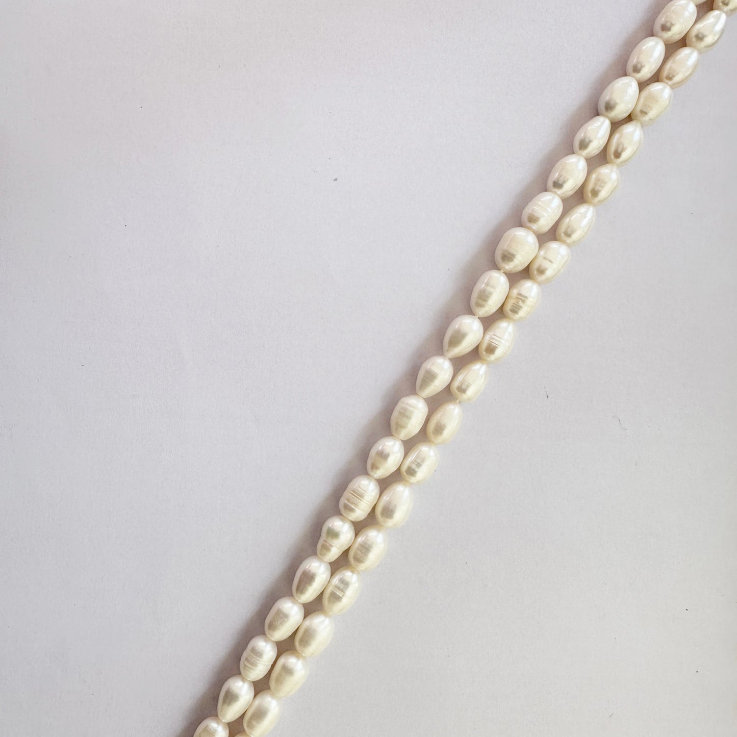 Oval pearls measuring 10–11mm long and 7–7.5mm wide strung with artisanal appeal.