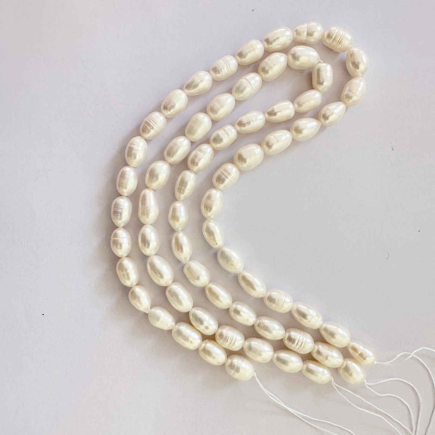 Textured pearl beads in oval shape reflect gentle sheen with organic charm.
