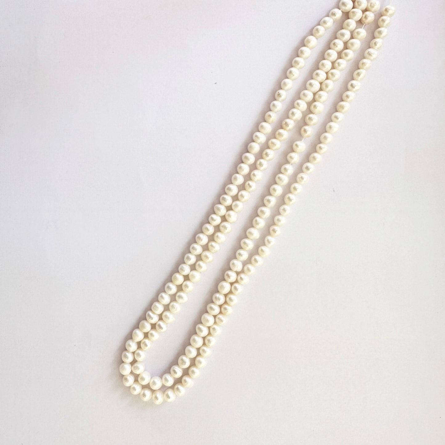 Smooth round pearls strung neatly across a 39cm strand for luxury beading.