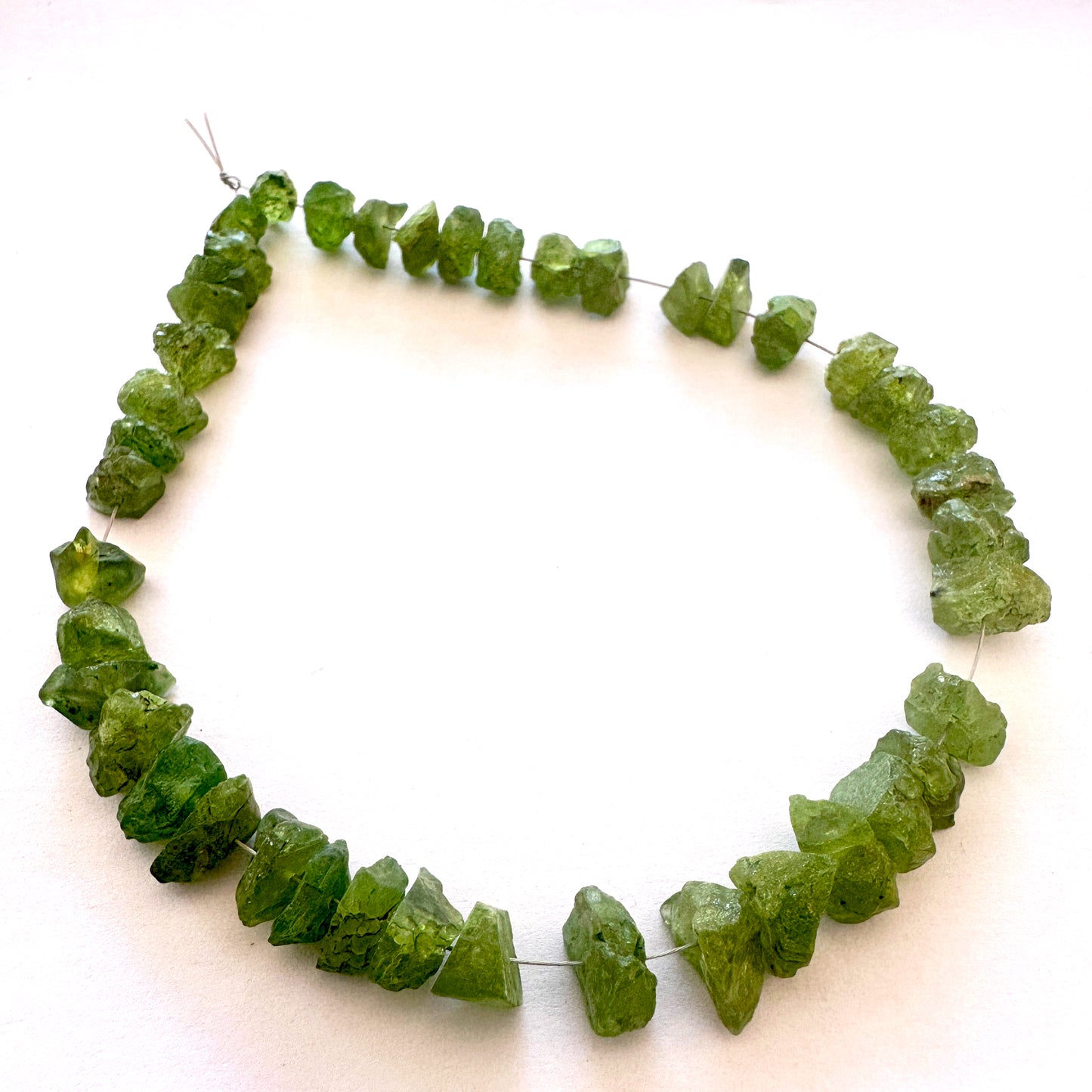 Peridot beads with 0.5mm holes, ideal for durable stringing and bold jewellery styles.