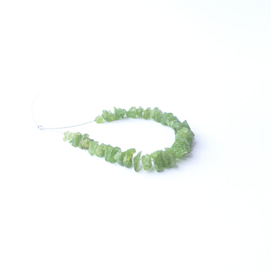 High‑quality Peridot drilled rough beads with lively green shine ideal for handmade jewellery components.