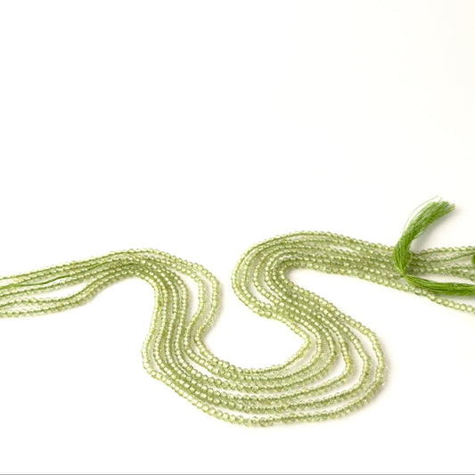 Genuine Peridot faceted rondelle beads in 1.9mm, arranged on a 31cm strand for handmade jewellery components.