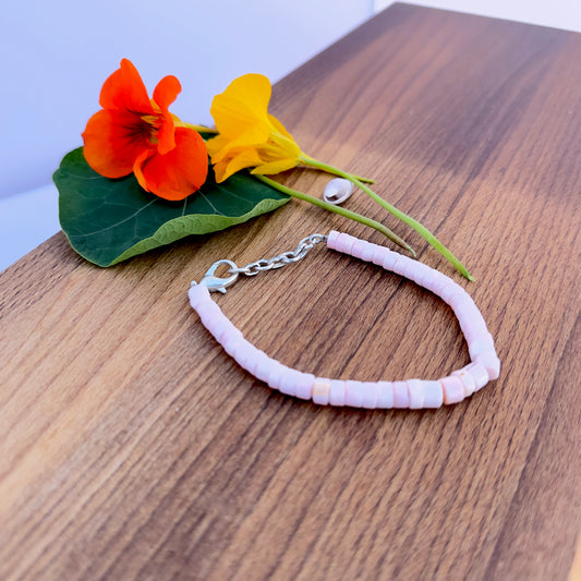 Close-up of Pink Opal gemstone beads showing polished finish and gentle colour.