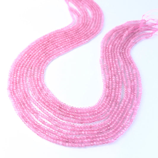 Faceted rondelle Pink Quartz beads arranged neatly, highlighting their polished finish and handmade jewellery component quality