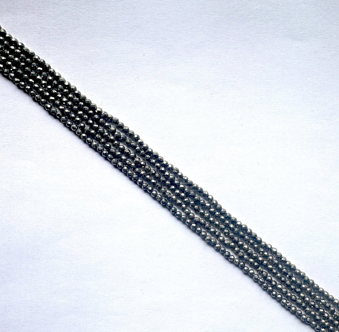 Pyrite rondelle beads showcasing golden-grey colour and precision faceting.