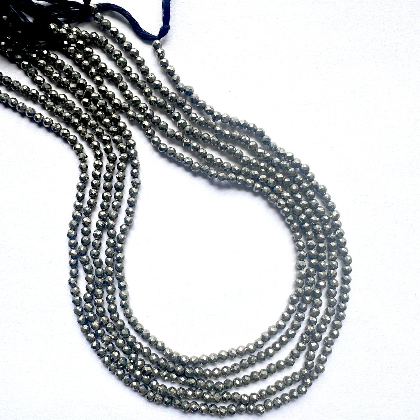A strand of faceted pyrite rondelle beads with metallic shine and smooth 3mm cut.