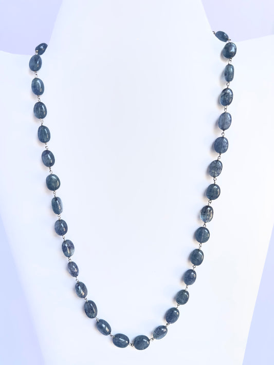 Elegant Quartz necklace, smooth oval beads, 224 carats of brilliance with silk tassel accent.