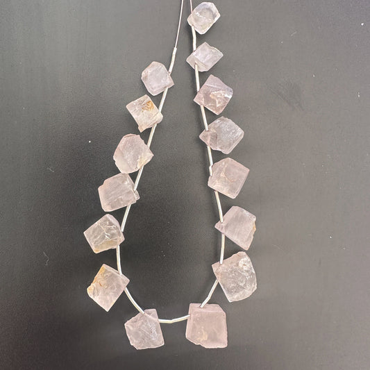 Quartz rough beads with translucent clarity and raw texture, arranged in a 15-piece pack.