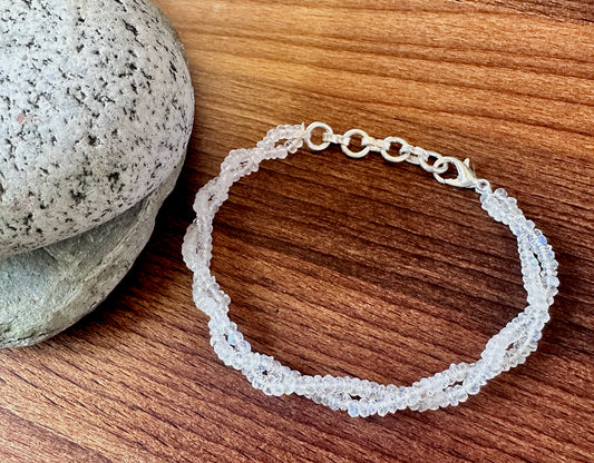 Close-up of rainbow moonstone bracelet featuring faceted rondelle stone beads, luminous glow and polished shine.