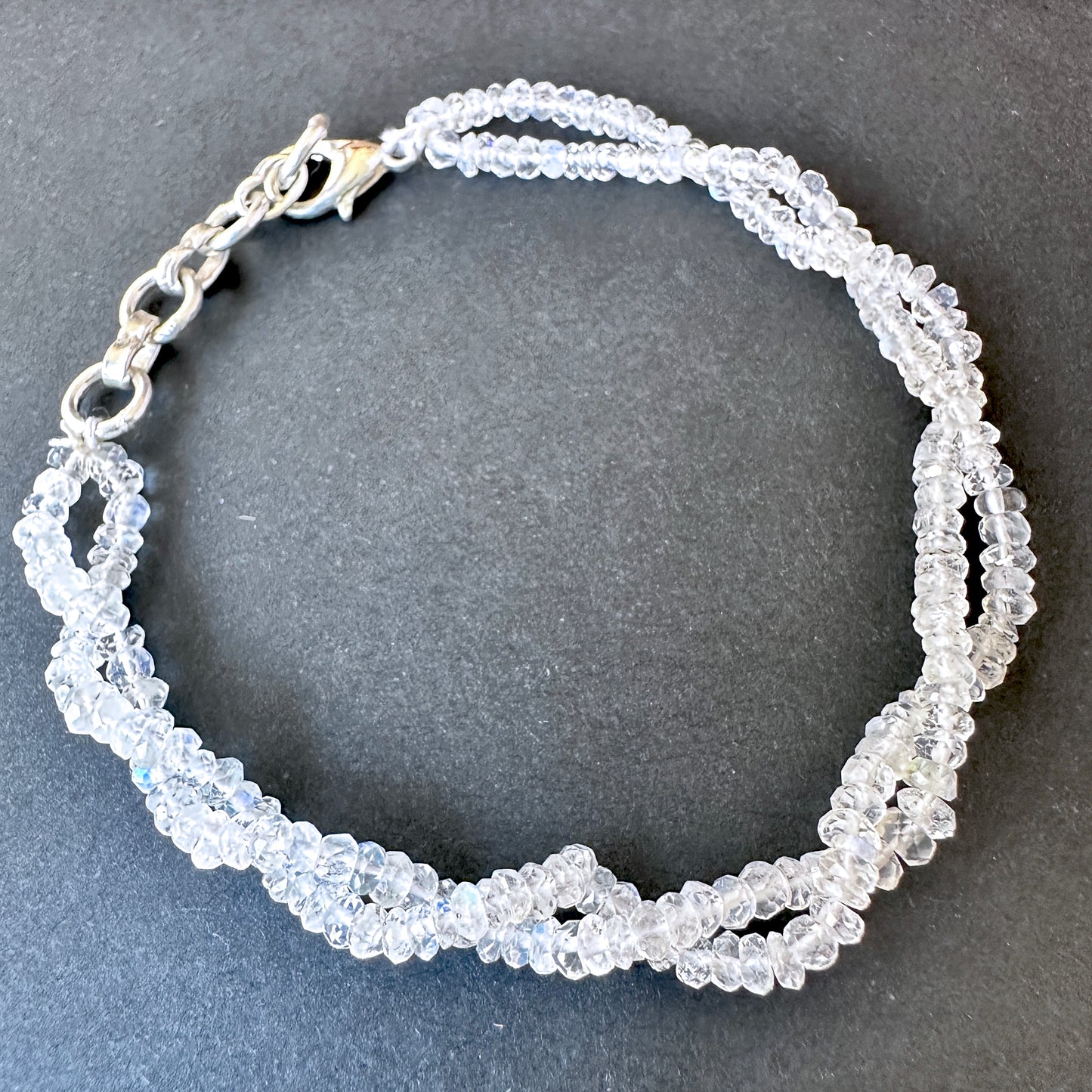 Elegant rainbow moonstone bracelet crafted from natural gemstone beads, 3mm faceted rondelles, adjustable 17.5cm length.
