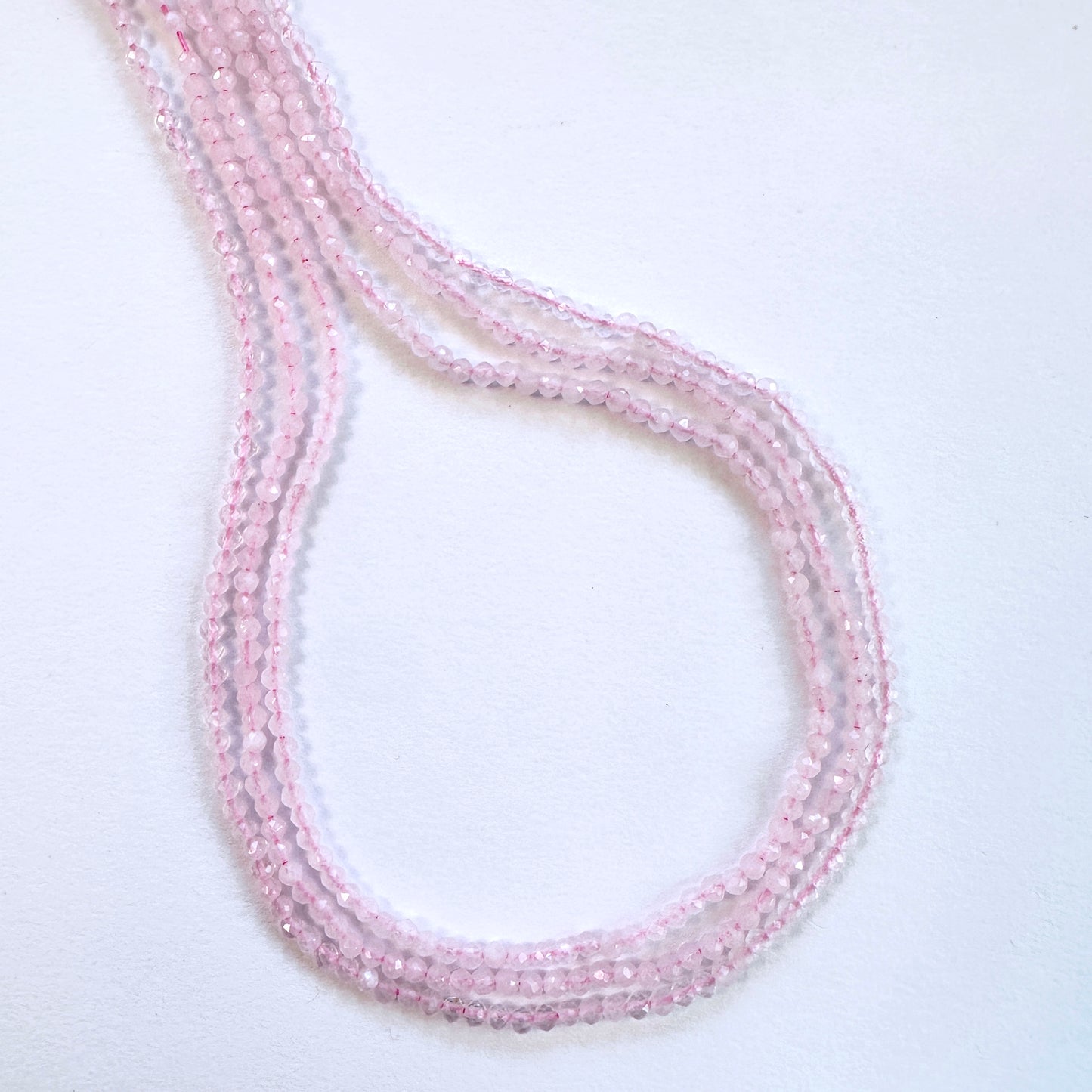 Rose Quartz stone beads with precise faceted rondelle cut and consistent shape.