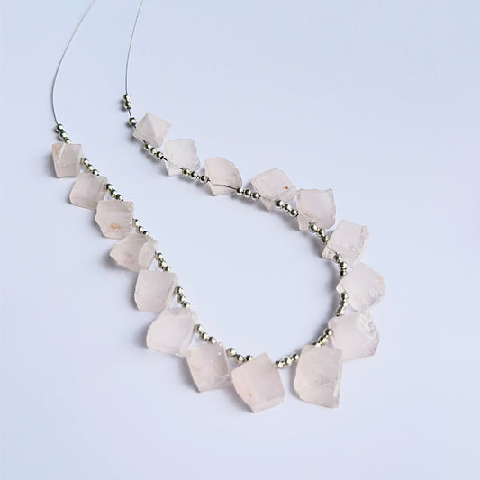 Rose quartz rough stones arranged neatly to showcase natural gemstone quality and handcrafted appeal.